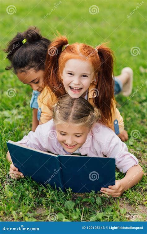 Beautiful Happy Multiethnic Girls Reading Book While Lying Together Stock Image Image Of