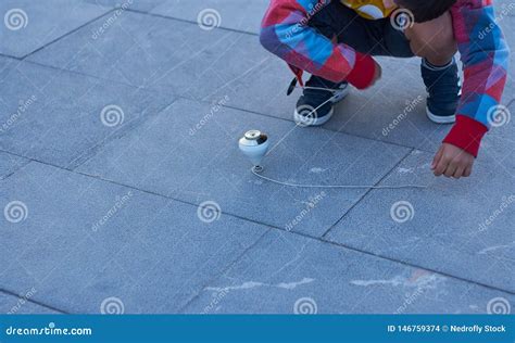 Child Catching The Spinning Top With The Rope Stock Photo Image Of