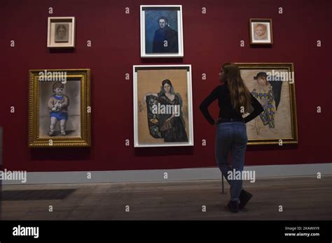 Employees pose during a press preview of ‘The EY Exhibition: Picasso