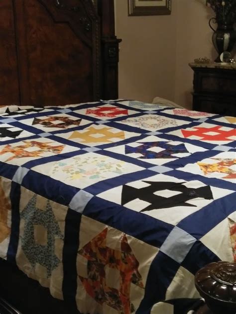 A Bed With A Blue And White Quilt On It