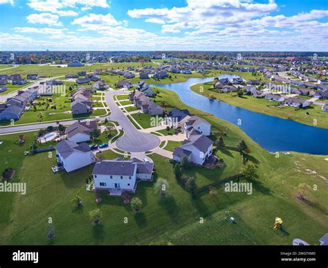 Aerial Suburban Bliss with Serene Waterfront and Lush Greenery Stock
