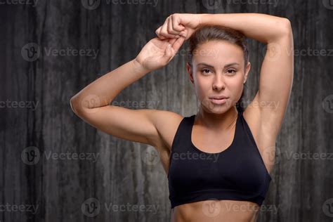 Close Up Of Mixed Race Sporty Woman Raising Arms Up Stock Photo
