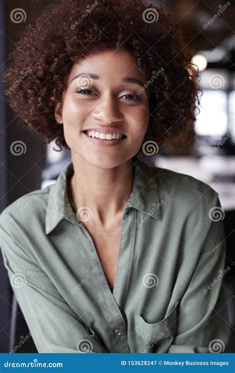 Close Up Portrait Of Millennial Black Female Creative In An Office Smiling To Camera Stock Image