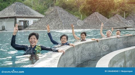 healthy asian elderly aging senior old friends exercising in swimming pool having fun enjoying