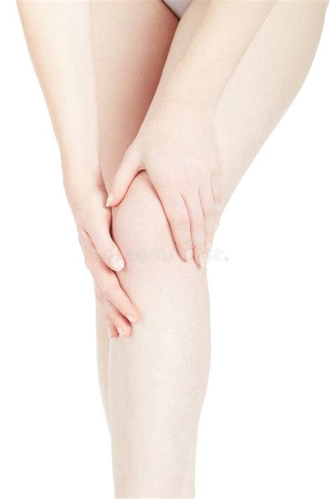 Young Woman Touching Her Leg Feeling Knee Pain On White Stock Image