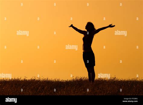 Silhouette Of A Woman With Her Arms Outstretched Stock Photo Alamy