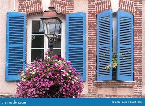 Normand Brick House With Blue Shutters And Flowers Stock Photo Image