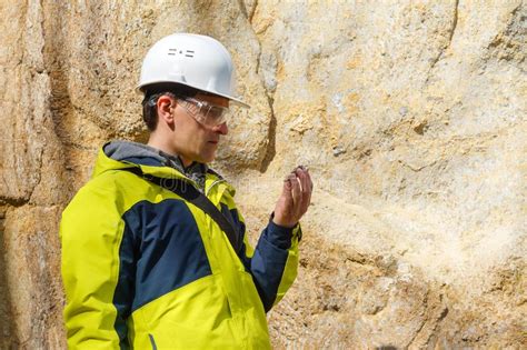 Geologist Examines A Sample Of Stone Outdoor Stock Image Image Of