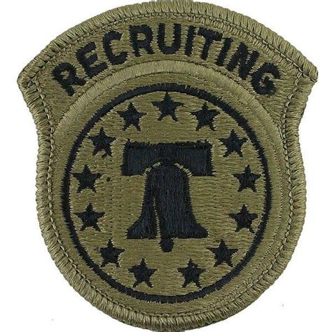 A Badge With The Word Recruiting Written In Black And Green On Top Of It