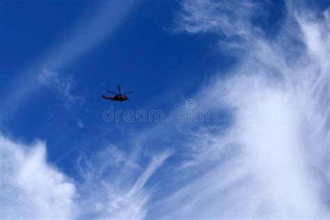 Rescue Helicopter In A Blue Sky Against A Background Of Clouds Stock