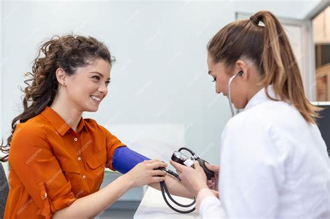 Premium Photo Measuring Blood Pressure Young Woman Have A Visit With