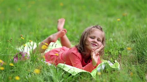 Little Girl Lying On Green Grass Stock Footage Video 100 Royalty Free