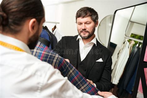 Customer And Tailor Selecting Cloth For Item Of Clothing Stock Photo