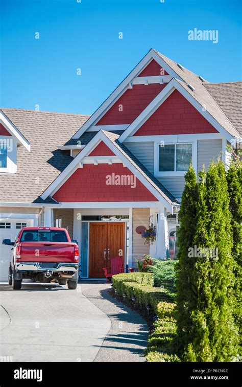 Entrance Of Luxury Residential House With Red Car Parked On The