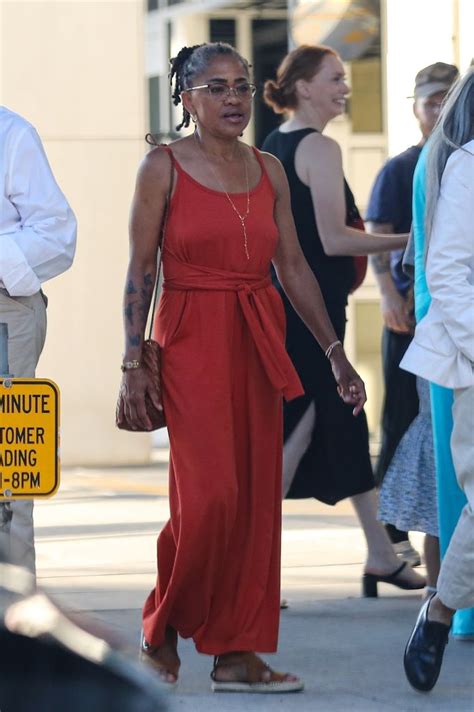 meghan markle s mom doria ragland 66 dazzles in red jumpsuit for surprise outing hello