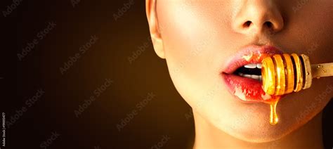 Honey Dripping On Sexy Girl Lips From The Wooden Spoon Beauty Model