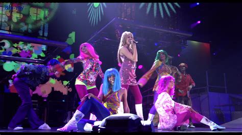 A Group Of Women On Stage With Bright Colored Hair And Makeup All
