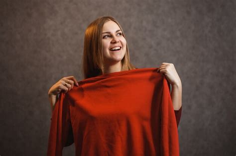 Premium Photo Beautiful Girl Tries On A Red Sweater