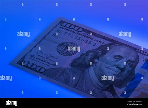 Checking 100 Dollar Banknote With Ultraviolet Lamp Examining Hundred