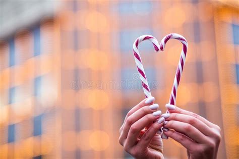 Woman Hands Holding Sweet Candies In A Heart Shape Stock Photo Image