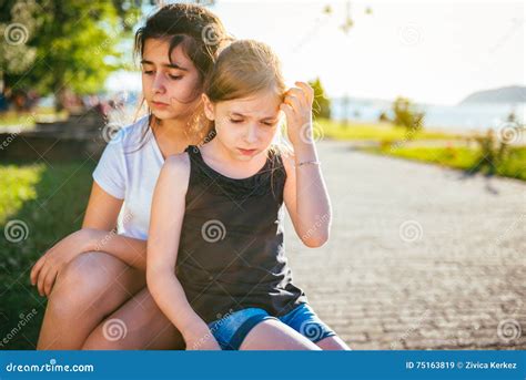 Two Sad Girls Sitting On A Bench In Park Stock Image Image Of Lost