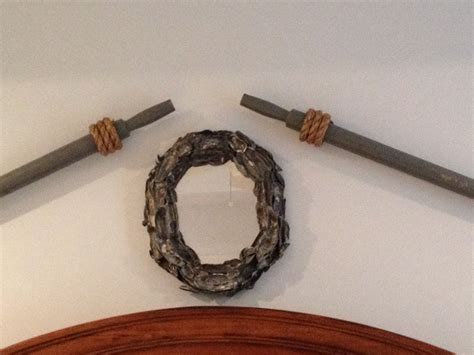 Using rope as trim or molding isn't much different than using other materials. Oars mounted to the wall using rope, wire and picture ...