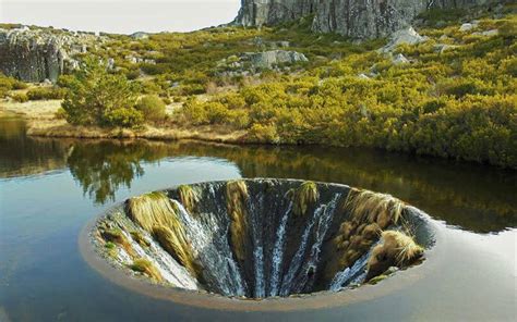 Covao Do Conchos Is A Waterfall Inside A Lake In Portugal