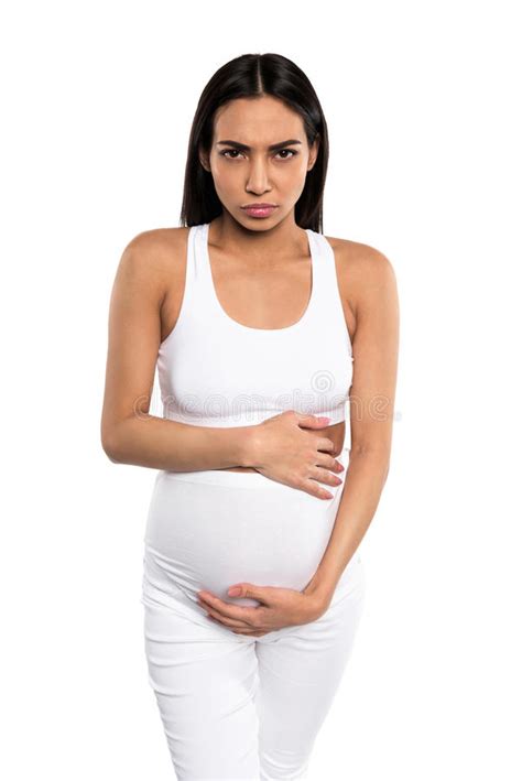 Worried Pregnant Woman In Nightie Feeling Pain And Touching Belly While