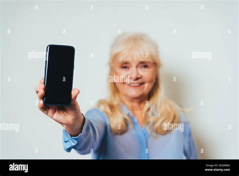 Beautiful Senior Woman At Home And Looking At Camera Smiling Pretty