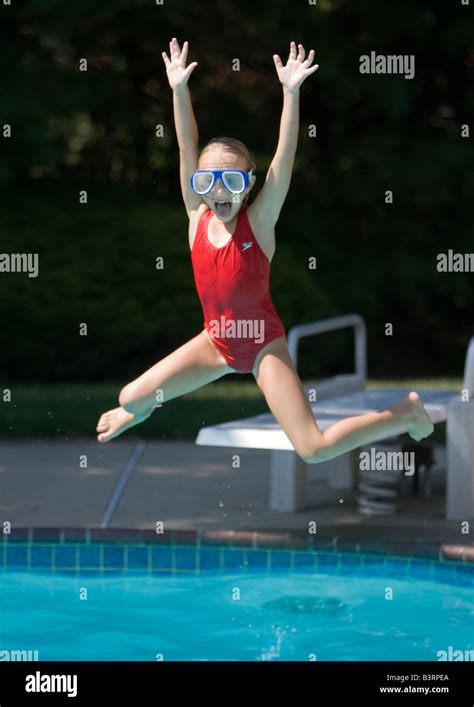 Child Jumping Into A Backyard Swimming Pool Stock Photo Alamy