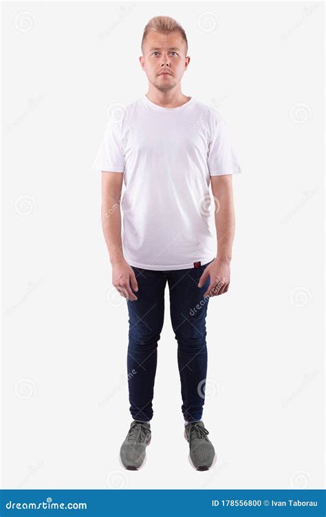 Man In Casual Wear Stands Straight Looks At Camera Full Length Stock