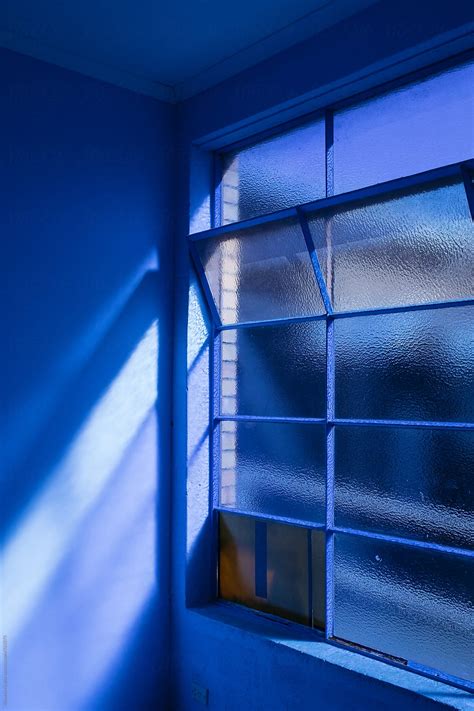 Natural Light Shining Through Blue Windows Into Painted Blue Room By