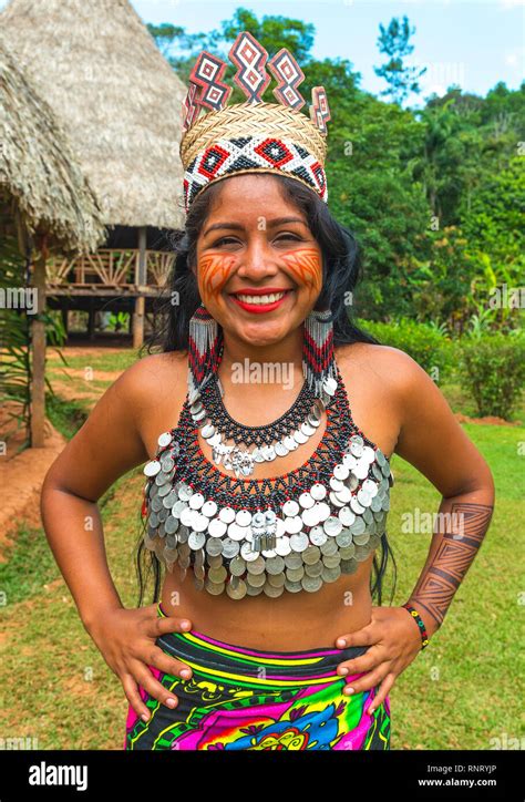 Portrait Of A Smiling Embera Indigenous Woman Posing In Front Of Traditional Housing In