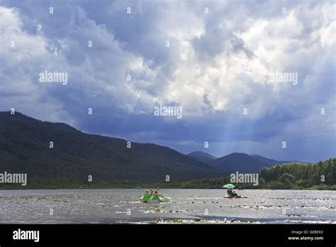 Sunrays Breaking Through Storm Clouds Over Mountain Lake Manzherok