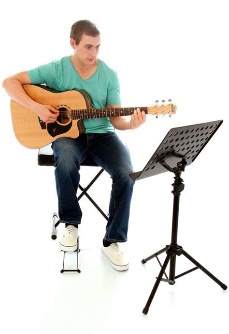 Some guitar teachers won't emphasize holding the guitar in this manner. How to Hold the Guitar - Learn to Play Music Blog