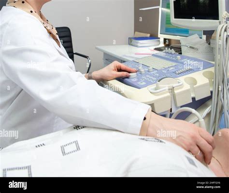 Young Woman Doing Neck Ultrasound Examination At Hospital Stock Photo