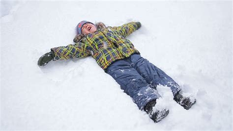 Adorable Little Boy Making Snow Angel Stock Footage Video 15598537