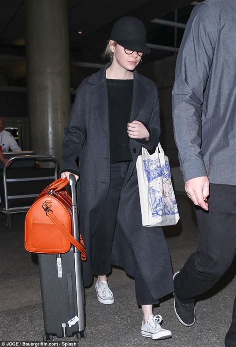 Emma Stone Keeps A Low Profile In Baseball Cap At Lax Daily Mail Online
