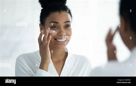 Mirror Reflection Smiling African American Woman Applying Moisturizing Cream Stock Photo Alamy