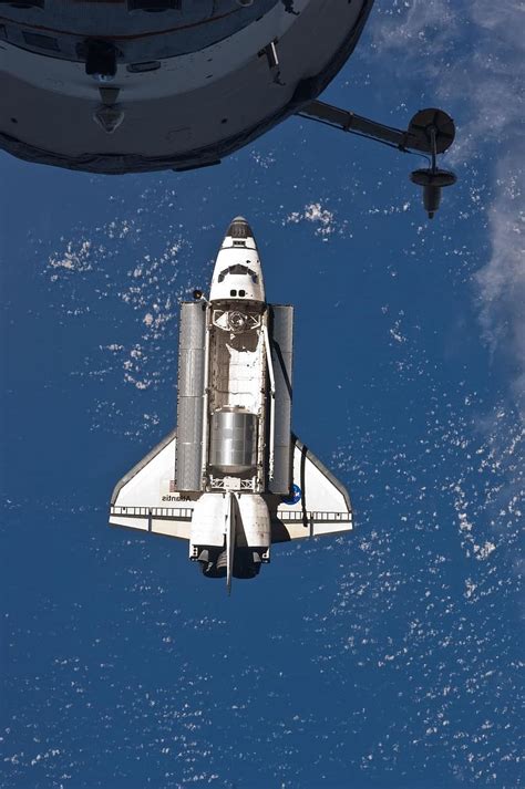 Space Shuttle Discovery Above Iss International Space Station