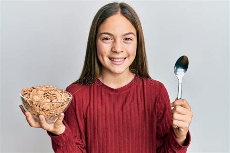 Beautiful Brunette Little Girl Eating Healthy Whole Grain Cereals