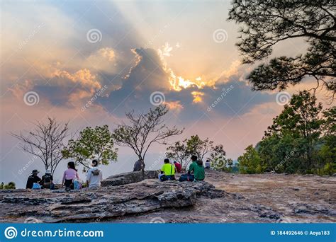 Tourists Sit And Watch The Sunset View At Mak Dook Cliff Phu Kradueng