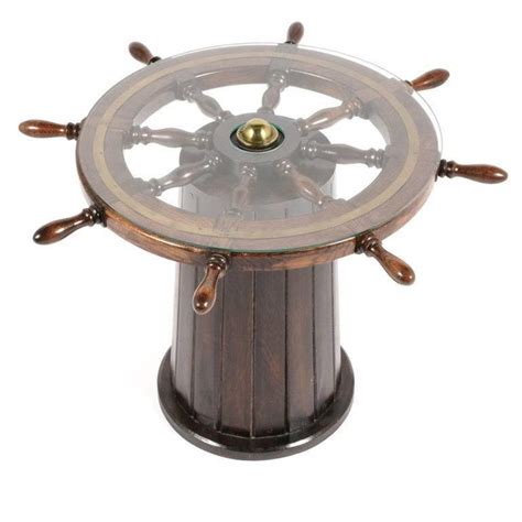 Interesting 20th century nautical style coffee table, with block and tackle base, teak ships wheel covered in glass as top. Ship's Wheel Table at 1stdibs