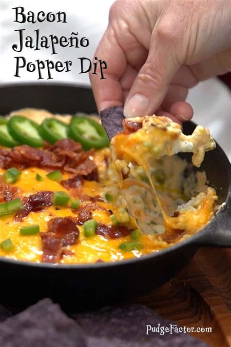Bacon Jalapeno Popper Dip In A Cast Iron Skillet Being Held Up With A