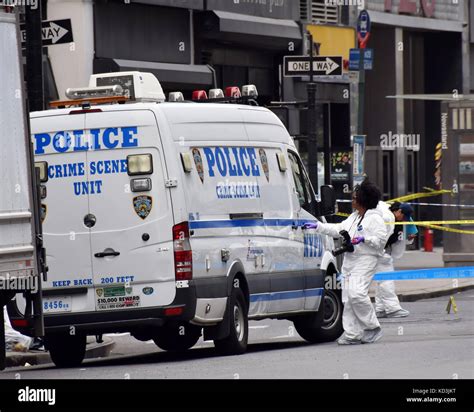 NEW YORK - MAY 13: NYPD Crime scene investigators probe the scene of a