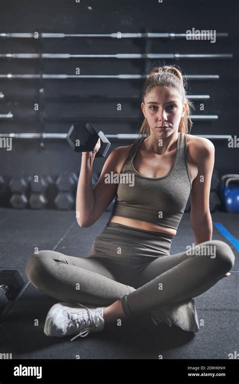 fitness woman exercising crossfit holding kettle bell and weight on black background female