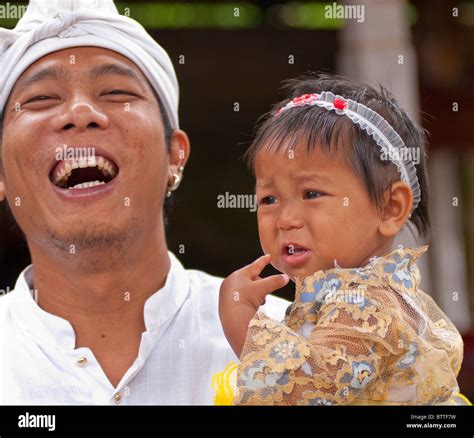 Father And Daughter Attending A Ceremony Near Ubud Bali Indonesia