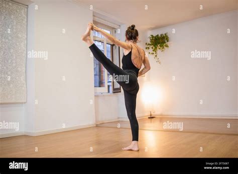 Side View Of Anonymous Flexible Barefoot Female Performing Extended