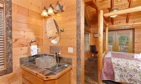 Each bedroom features homey additions like end tables, reading lamps, windows, ceiling fans, and its own tv. Gatlinburg Cabin Rentals - Splashin Treehouse