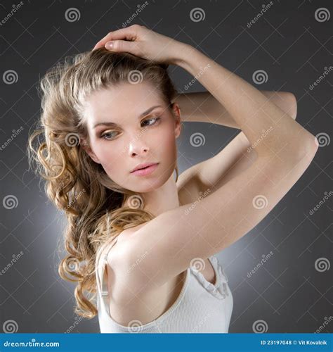Blonde Raised Her Hand To Her Hair And Looks Directly Into The Camera Stock Photography
